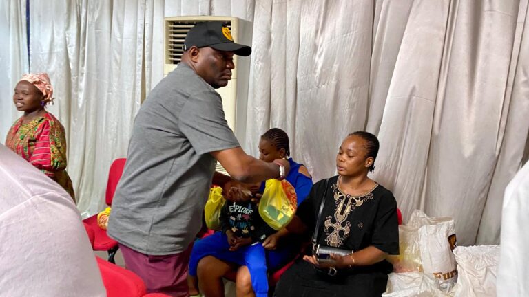 Women receiving welfare packs at an HTWC outreach