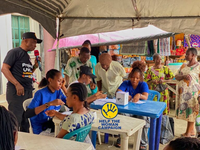 Volunteers running health checks at a market outreach