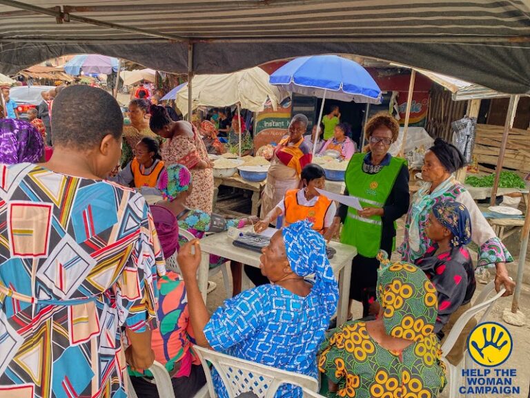 Women having health checks under a market canopy